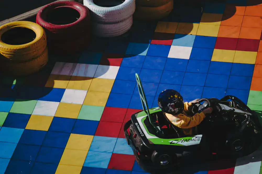 Screenshot of cartoon karts racing through a colorful obstacle course