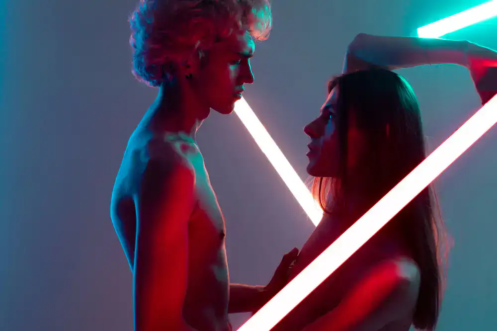 Vibrant neon platformer level showing two characters helping each other